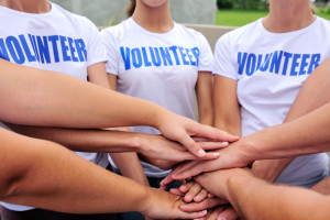 Volunteer group joining hands